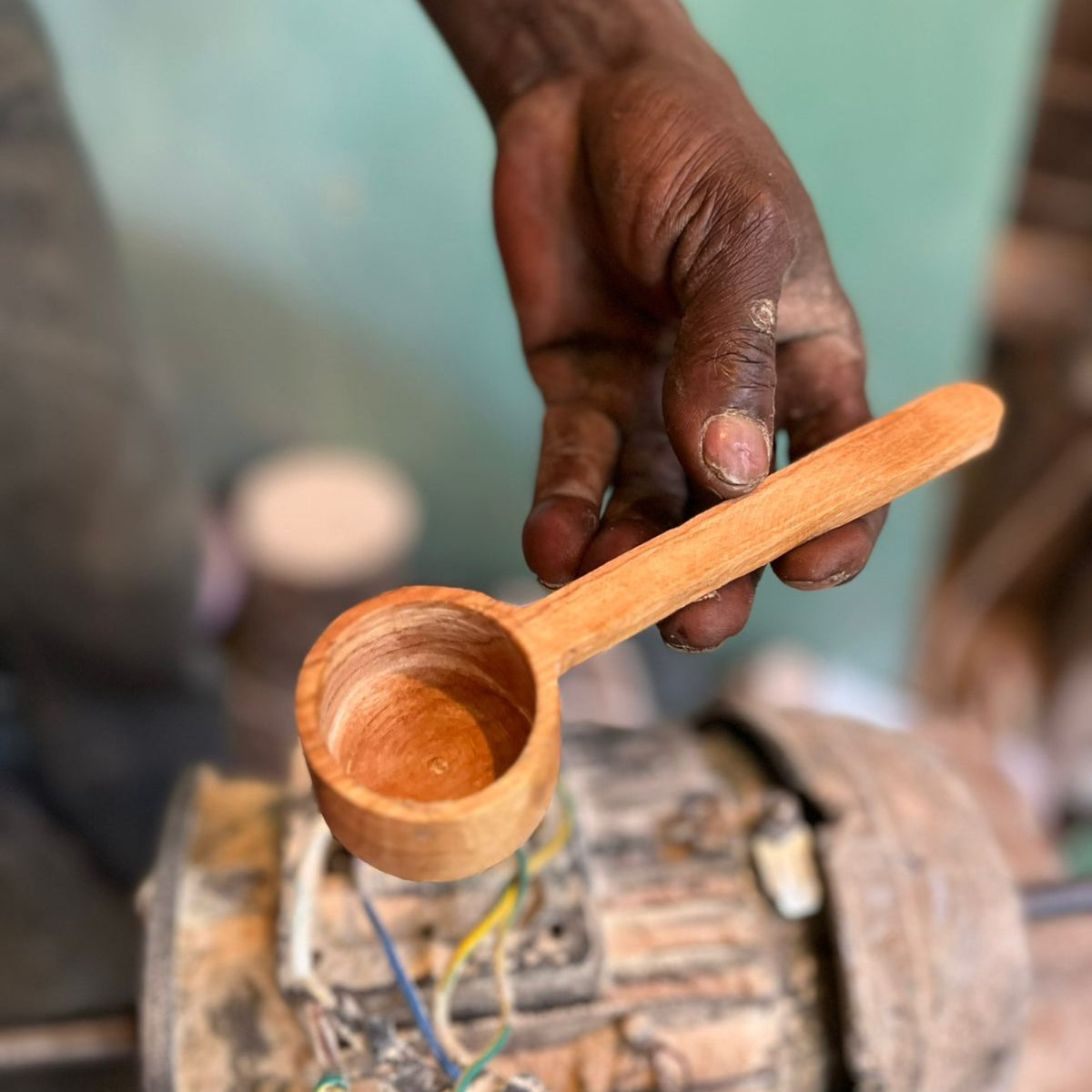 Olive wood coffee scoop being carved in the workshop